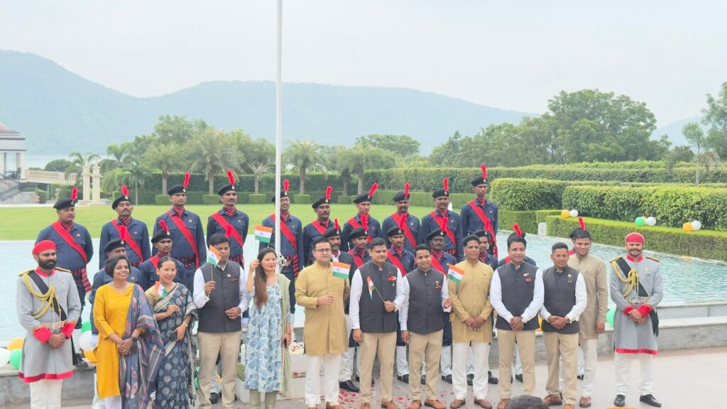 Raffles Udaipur team in traditional Indian attire holding Indian flags, celebrating Independence Day