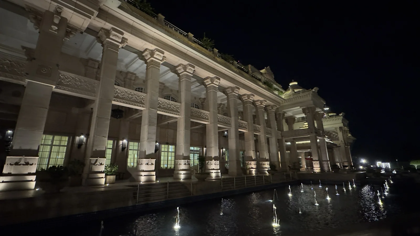 Colonnade and water fountains at ITC Grand Bharat, a Luxury Collection Retreat, at night
