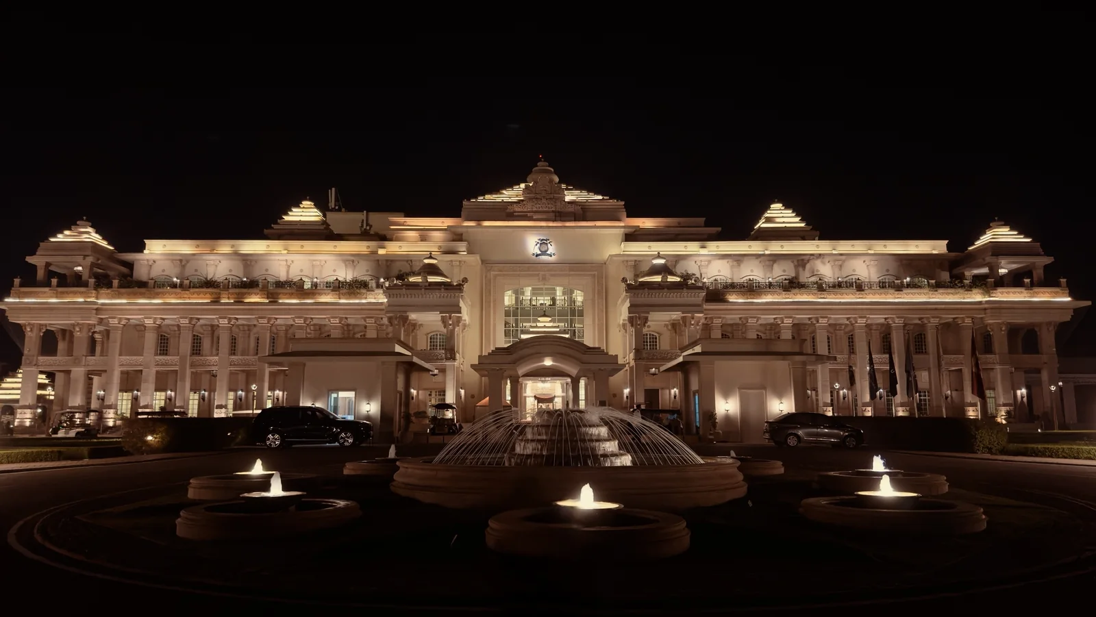 ITC Grand Bharat Gurugram main palace facade lit up at night with fountains in front