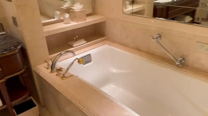 Marble bathroom with a deep bathtub at The Leela Palace New Delhi Royal Premier Room